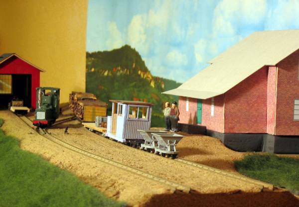 Bosjön stn med hus, fordon och figurer.